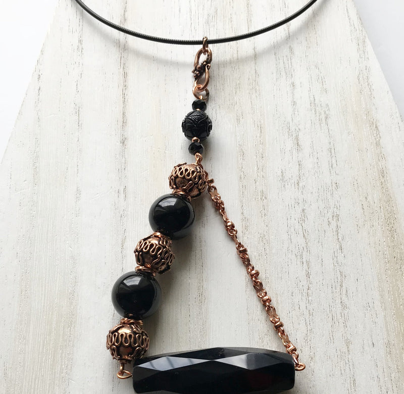 Statement necklace with semiprecious black onyx and copper metals